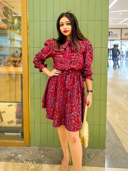 The dress against a green background, which makes the red color pop even more.