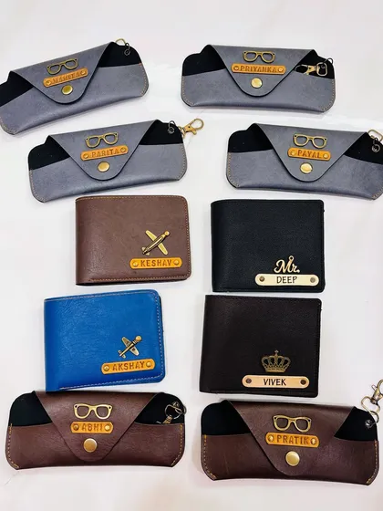 It's all in the details. I offer a range of personalized accessories like these wallets and spectacle cases. You can add a name and a special charm to make it a truly one-of-a-kind gift for him.