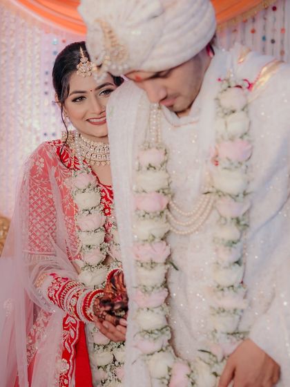 A shy, sweet moment during a North Indian wedding ceremony. The bride peeks at her groom, her smile full of love and admiration.