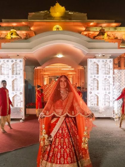A royal bridal entry fit for a queen. For Aishwarya's entrance, we created a regal pathway lined with dancers in traditional red attire and sparkling cold pyros, making her walk to the stage a showstopper.