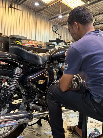 A mechanic carefully working on a 1996 Royal Enfield Bullet 350, one of several classics in our workshop.