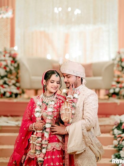 A sweet and tender portrait of the couple, their beautiful floral garlands adding a touch of tradition and color.