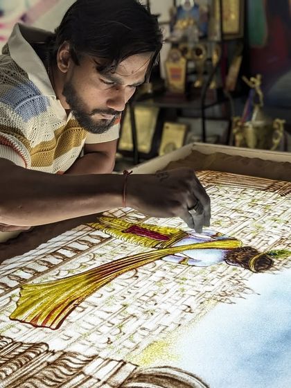 Another angle of me working on the Lord Krishna sand art. I use colored sand to bring vibrancy and life to these divine stories.