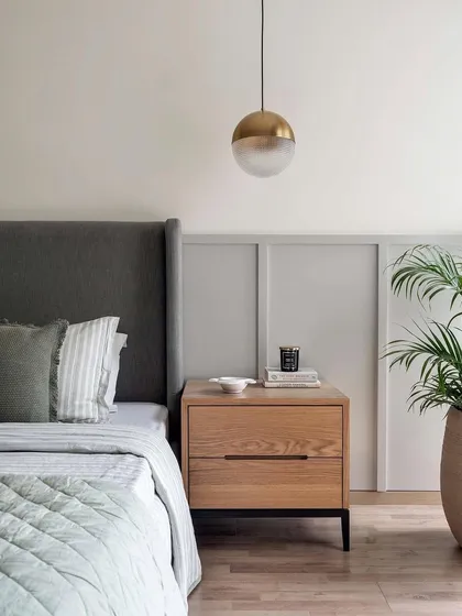 Another bedroom from the same Weespaces project, this time with our custom bed with a simple grey upholstered headboard and a light oak nightstand with a metal base.
