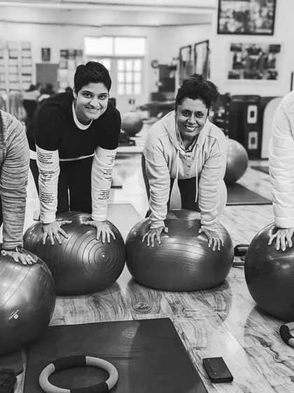 A black and white shot of our strong ladies ready to work on the stability balls.