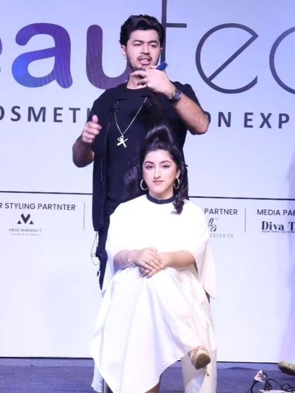 Demonstrating a haircut on stage. These live sessions are a fantastic opportunity to teach and inspire other hair professionals.