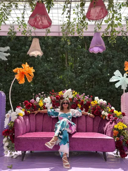 Spreading my arms wide to embrace the grand and colorful decor of the wedding carnival.