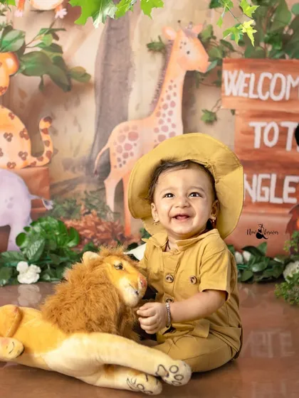 Welcome to the jungle! This little explorer's bright smile and safari outfit bring so much personality to our jungle-themed milestone session. It’s all about capturing their budding curiosity.
