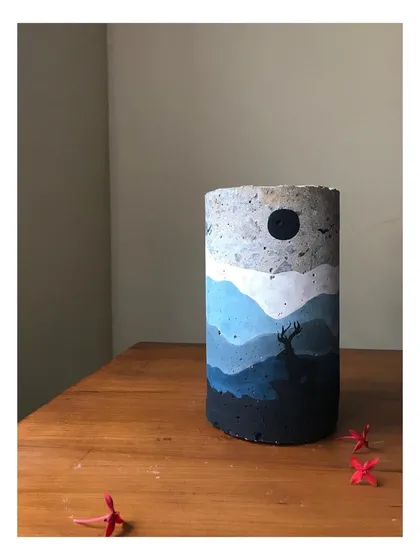 This is the night-themed sculpture from the 'Mystic Mountains' collection. The cool blue palette and solitary deer evoke a sense of tranquility. It is an art curio designed to bring a touch of the wild into your interior space.