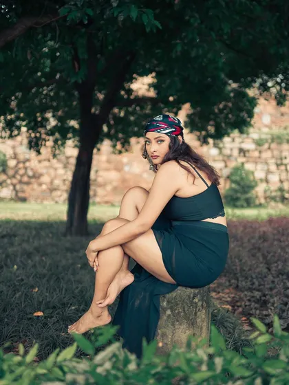 A different pose from the same series, this one feeling more vulnerable and introspective. The natural green background adds to the calm, thoughtful mood.