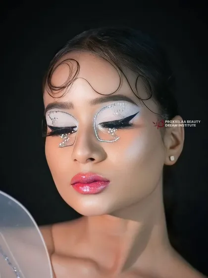 Eyes closed, the glitter and graphic liner take center stage. This is a look that is beautiful from every angle, full of detail and imagination.