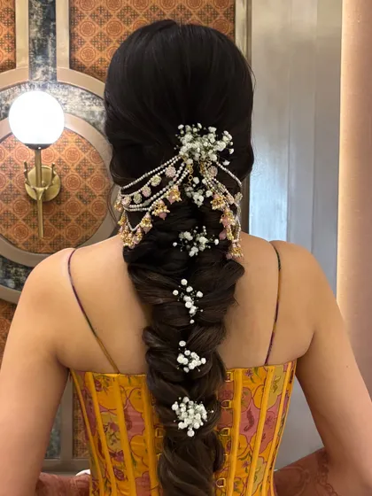 This intricate bridal braid is a true statement piece. You will learn the techniques for creating a full, textured fishtail braid and how to layer it with stunning hair jewelry and delicate baby's breath for a breathtaking result.