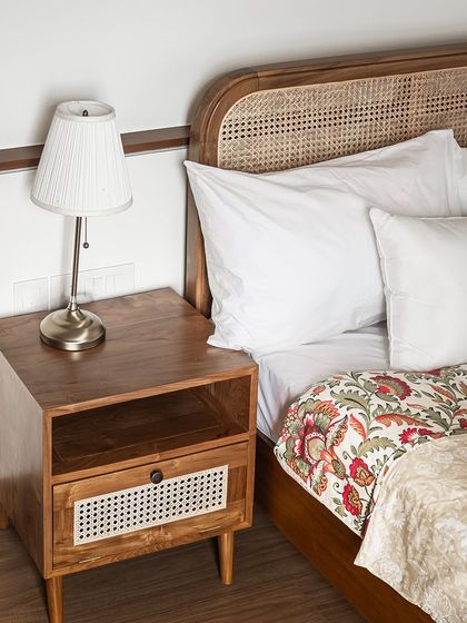 My teak wood side table, sculpted from nature’s finest material. The design includes an open shelf and a drawer with a rattan front, offering both beauty and functionality.