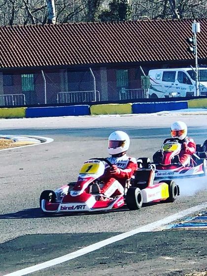 A train of Birel ART karts during a practice session in Italy, perfecting their lines and working on race simulations.