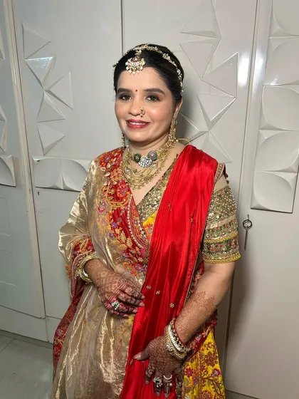 A smiling portrait of the mother of the bride. Her makeup is radiant and timeless, ensuring she looks and feels her best on her daughter's special day.