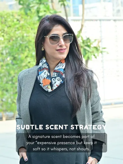 A signature scent is a subtle but powerful part of your presence. Here, I've paired a classic blazer with a printed scarf, an example of how accessories and scent can whisper, not shout, luxury.