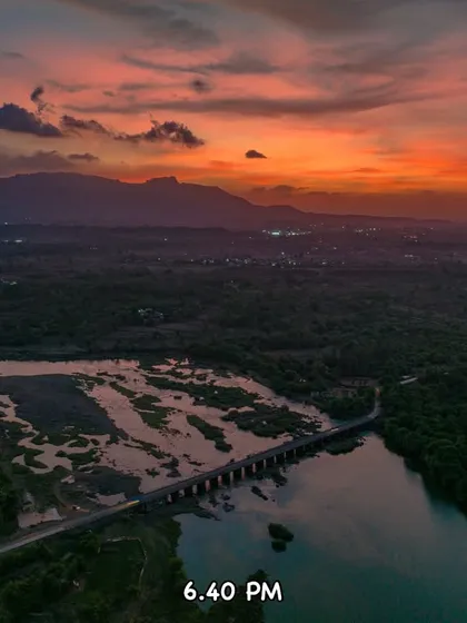 The Tahuli Peak during sunset at 6:40 PM. The sky is on fire with deep orange and red hues over the landscape of Badlapur.