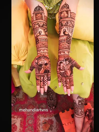 Here you can see a full bridal design that incorporates multiple personalized elements, from couple portraits on the palms to architectural domes and figures on the arms.