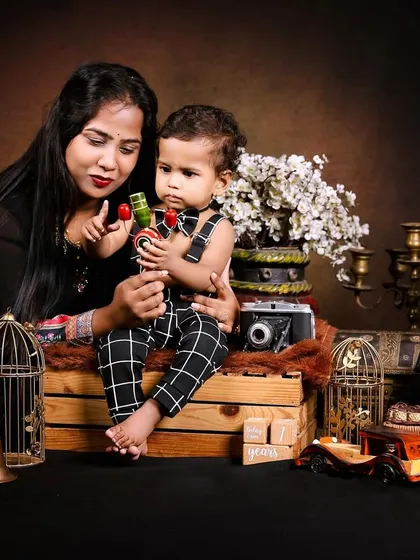 A mother and son share a moment during a vintage-themed photoshoot.