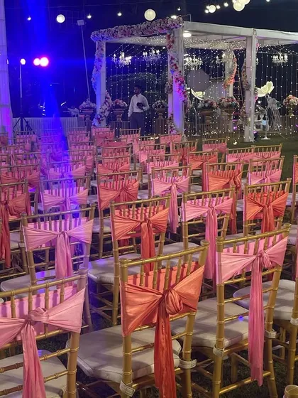 Another angle of the guest seating, showing the attention to detail in the chair decorations. Consistent and beautiful seating is key to a polished event look.