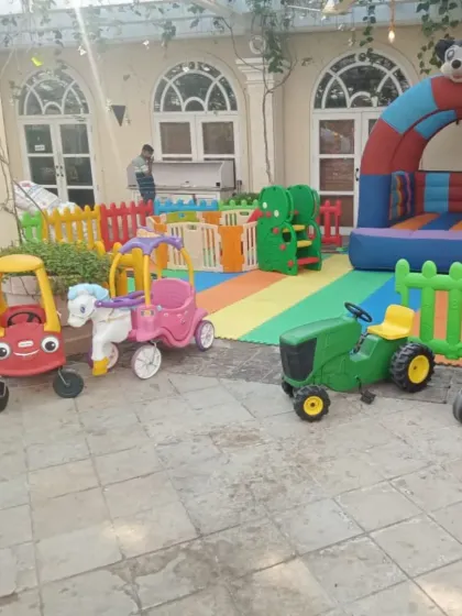 This party setup on a beautiful tiled patio shows how versatile my playzones are. I brought in a fleet of ride-on cars, including a police car and a tractor, along with a Mickey Mouse themed bouncy arch, creating a perfect race-track feel for the kids.