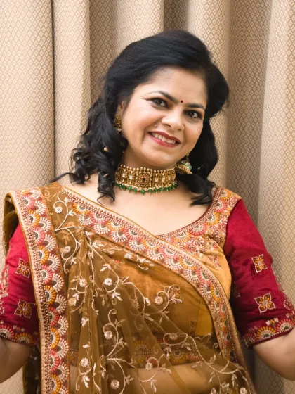 A smiling close-up that shows the joy of the occasion. This shot focuses on the model's face, makeup, and the choker necklace.