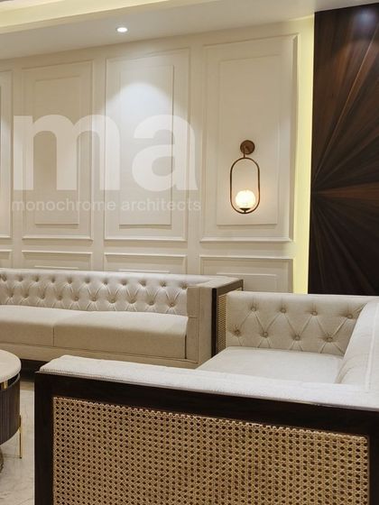 The side view of this Chesterfield sofa reveals the beautiful rattan work on its arms, a detail that adds texture and a touch of bohemian chic to the otherwise classic and formal design.