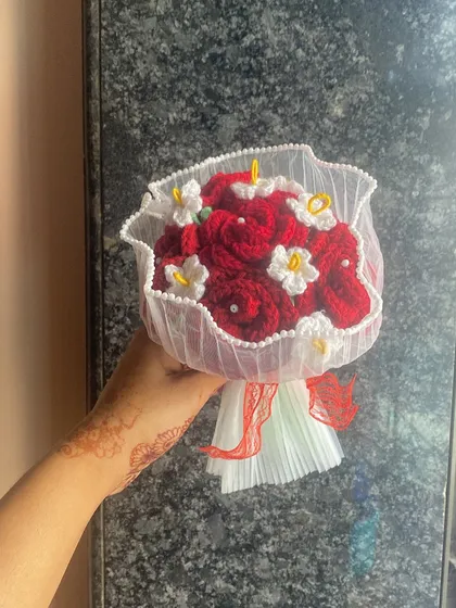 A classic red rose bouquet for a timeless declaration of love. Here, the deep red crochet roses are accented with tiny white flowers and wrapped in delicate white netting.