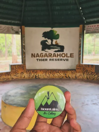 Our branded badge held up against the Nagarahole Tiger Reserve sign. We are proud to bring travelers to experience the rich biodiversity of Karnataka.
