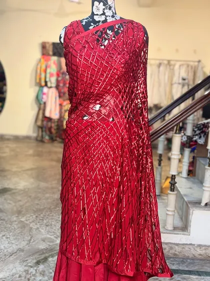 Another look at the stunning 'LAALPARI' saree in our studio. The vibrant red is a classic, but the design is anything but ordinary.