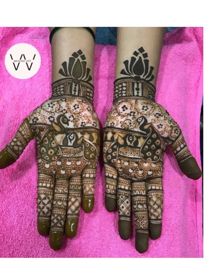 A stunning design for a bridesmaid with two large peacocks and lotus cuffs.