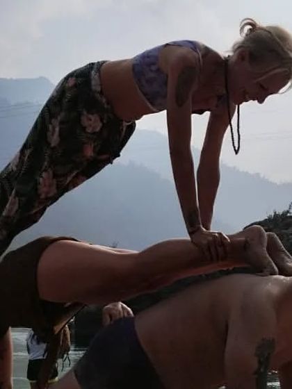 The triple plank challenge by the river. This acro yoga stack requires immense core strength and stability from all three people.