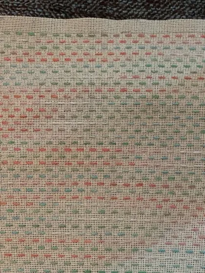 The back of the embroidery work, showing the neatness that is a hallmark of this craft. This piece is ready to be sewn into a pouch or case.