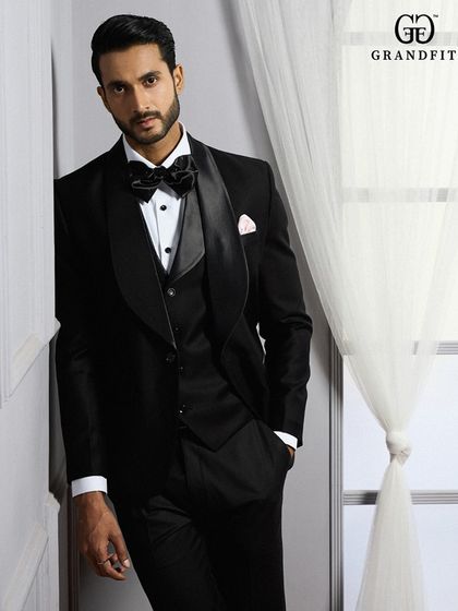 This three-piece tuxedo demonstrates our dedication to layered elegance. The coordinating waistcoat adds depth and formality, ensuring a polished look from every angle.
