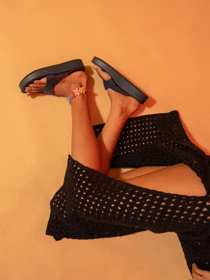 A playful product shot focusing on the footwear. This kind of creative angle is perfect for social media campaigns.