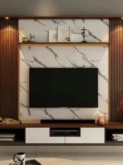 This is a great example of a modern TV unit I designed. It combines a marble-finish back panel with wooden fluted panels and integrated spotlights for a luxurious look.