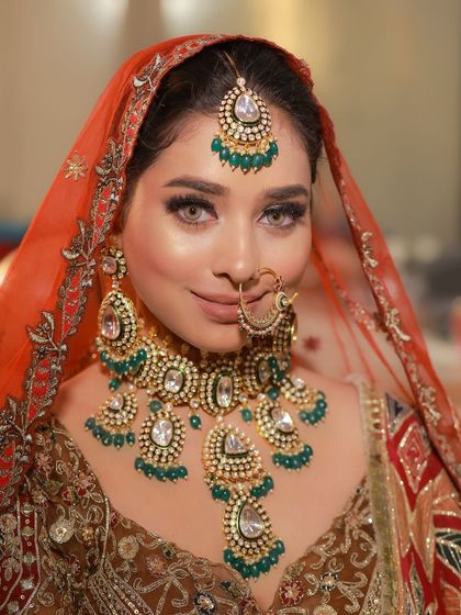 A perfect example of a full glam bridal look. The heavy jewelry and dramatic eyes come together to create a truly unforgettable statement.