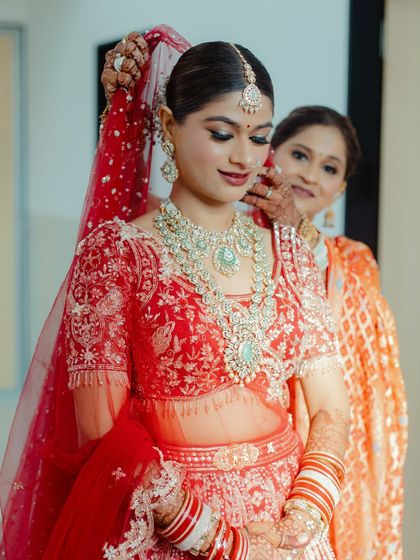 A sweet moment as the bride's mother helps her get ready. These are the memories that last a lifetime, and I ensure my brides look and feel their best for them.