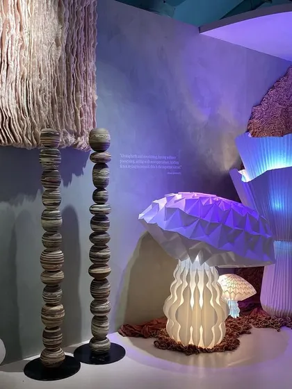 Glowing mushroom lamps from the 'Shroom' installation. These pieces, created through paper folding, add a whimsical and magical element to the mycelic landscape.