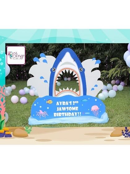 A "Jawsome" second birthday with this fun Under the Sea theme. This custom-made shark photo-op prop provided a fun and interactive element for the little guests at Ayra Yash's party.
