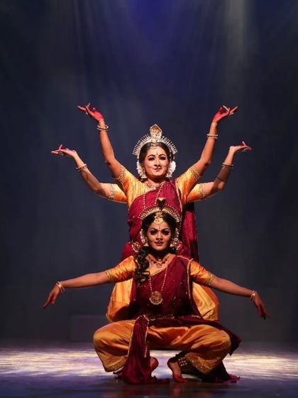 A beautifully synchronized moment from "Shrishti Stithi Laya". The three dancers move as one, their forms highlighted by dramatic spotlights, embodying the principles of creation, preservation, and dissolution.