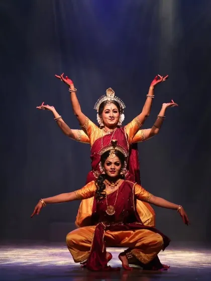 A beautifully synchronized moment from "Shrishti Stithi Laya". The three dancers move as one, their forms highlighted by dramatic spotlights, embodying the principles of creation, preservation, and dissolution.
