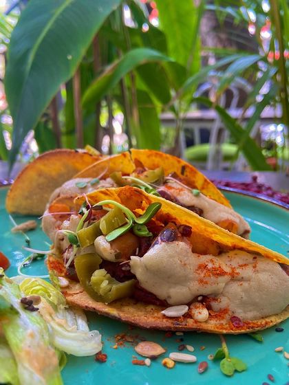 A closer look at our delicious plant-based tacos. The combination of savory refried beans, creamy cashew cheese, and fresh toppings makes for an irresistible and healthy indulgence, perfect for a weekend treat.