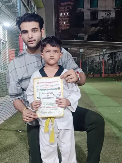 Another young warrior proudly holding his tournament certificate. We encourage all our students to test their skills in competition.