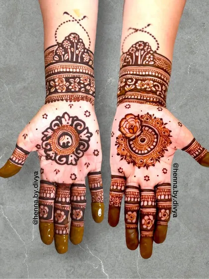 A lovely design combining a central elephant mandala on one hand and a floral mandala on the other. The top cuff features a baraat (wedding procession) scene, adding a narrative element.