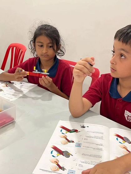 Students from Vidyashilp Academy are deep in concentration during our after-school program, learning to build complex models from instruction booklets.