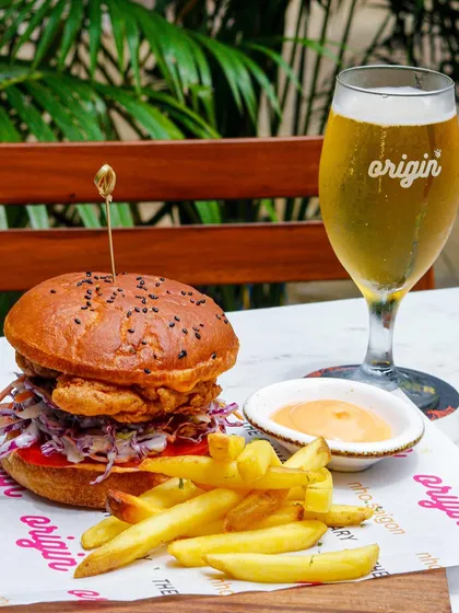 The perfect pairing: a juicy burger with a side of fries and a cold glass of beer.