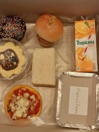 A clear shot of the contents, showing how each item is carefully placed. From the savory sandwich to the sweet cupcake, it's a balanced meal that kids genuinely love to eat.