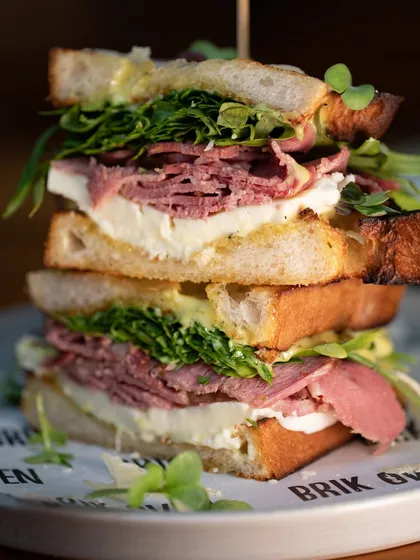 Meet our stacked pastrami sandwich. We pile tender pastrami, our fresh, handmade mozzarella, and crisp greens between slices of our naturally leavened sourdough. It’s a full meal and a testament to our love for big, bold flavors.