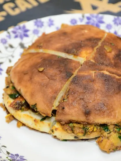 Our Baida Roti, stuffed with a flavourful filling and cooked on the tawa until golden brown. It is cut into pieces, making it easy to share.